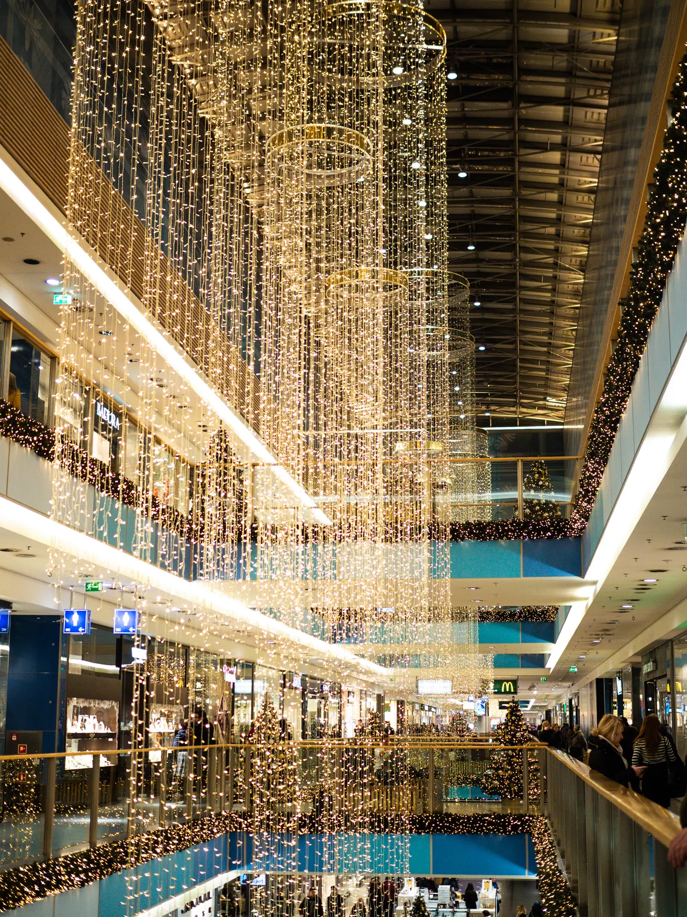 Center of Galeria Kazimierz shopping mall decorated with Christmas lights and garlands in Krakow during Christmas.