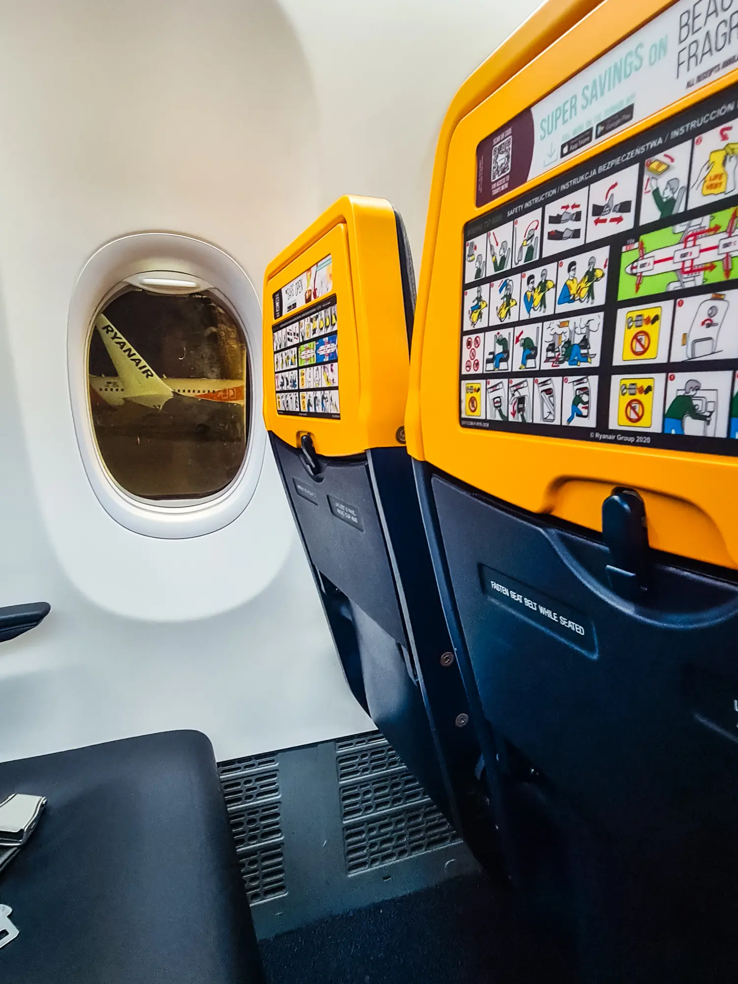 Looking from the aisle seat out the window on another Ryanair plane at the airport gate.