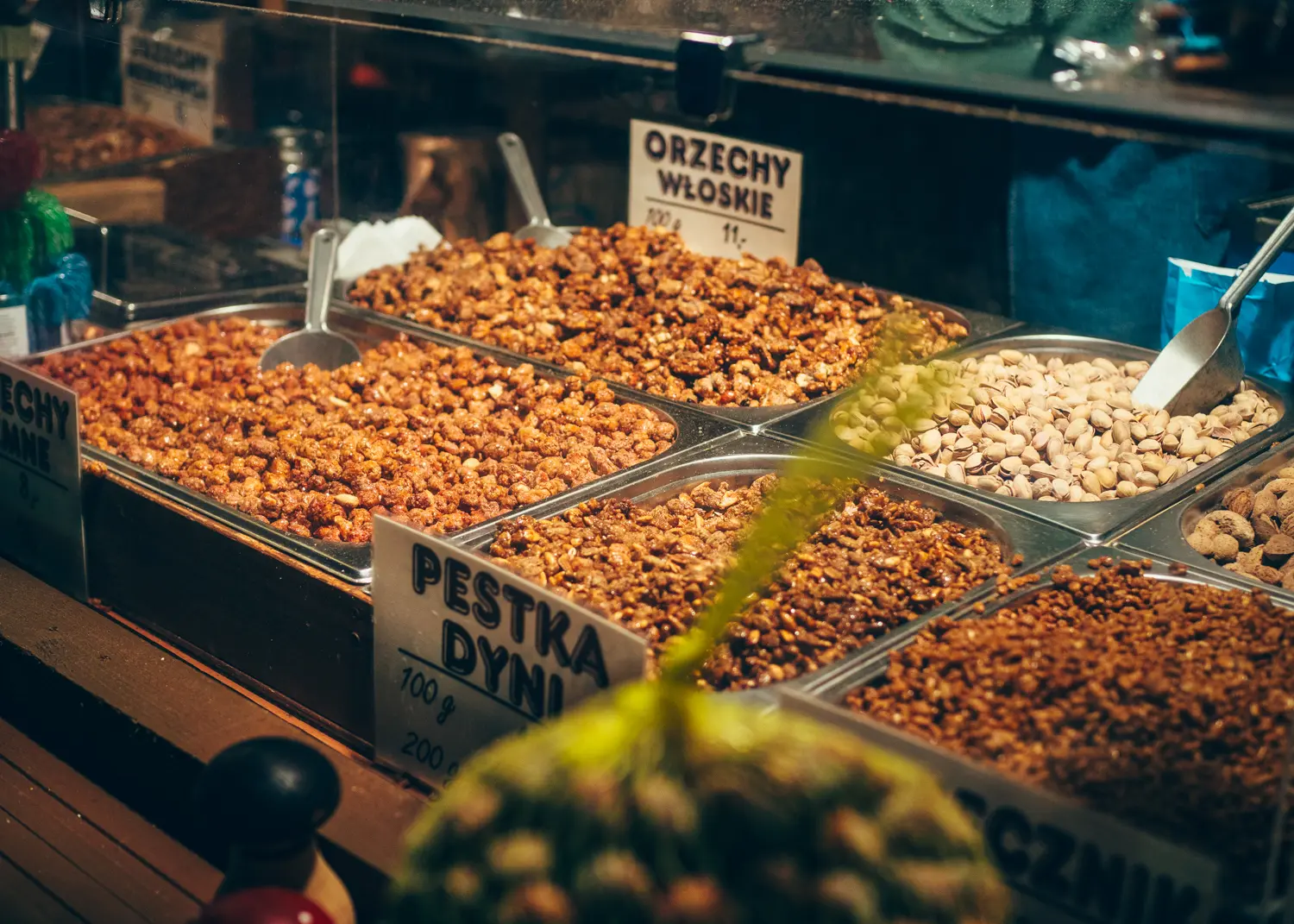Stall displaying big trays of different nuts to buy as a snack or gift at Krakow Christmas Market.
