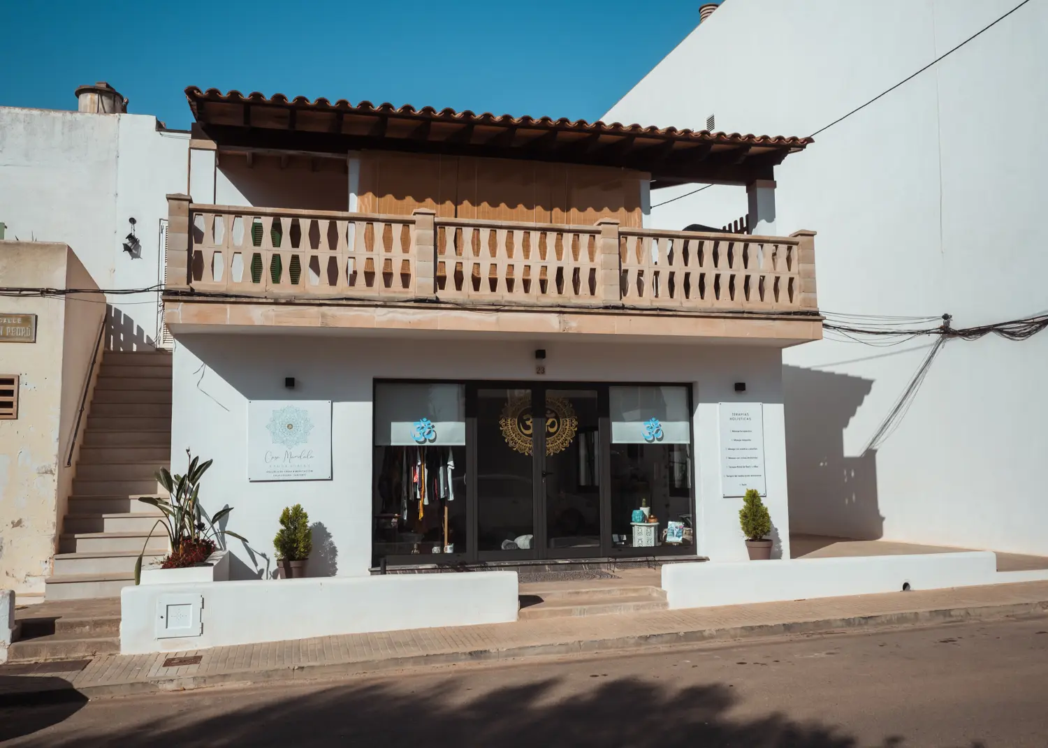Small white building with wooden veranda, Casa Mandala Yoga Shala in Cala Figuera, Mallorca.