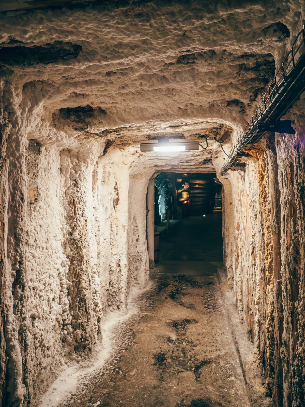 Tunnel with salt on the walls and ceiling leading deeper into Wieliczka Salt Mine, Krakow.