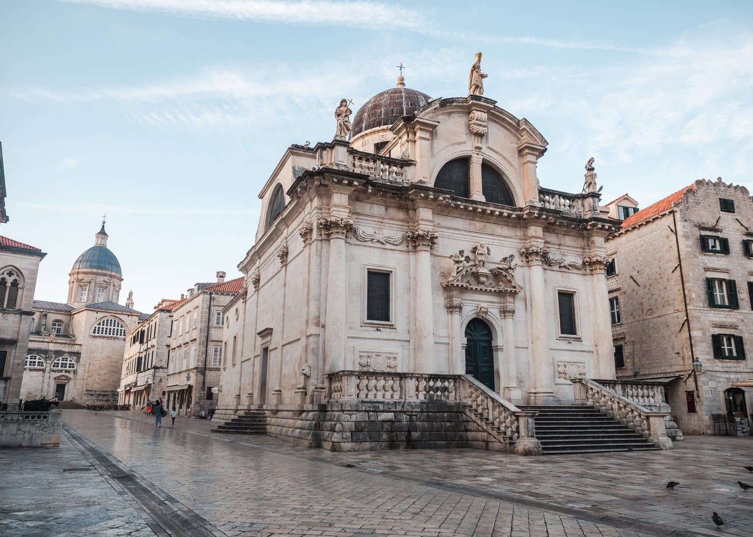 Ornate sandstone Saint Blaise’s Church surrounded by cobbled streets with other beige buildings in the background of Old Town, Dubrovnik Pass.