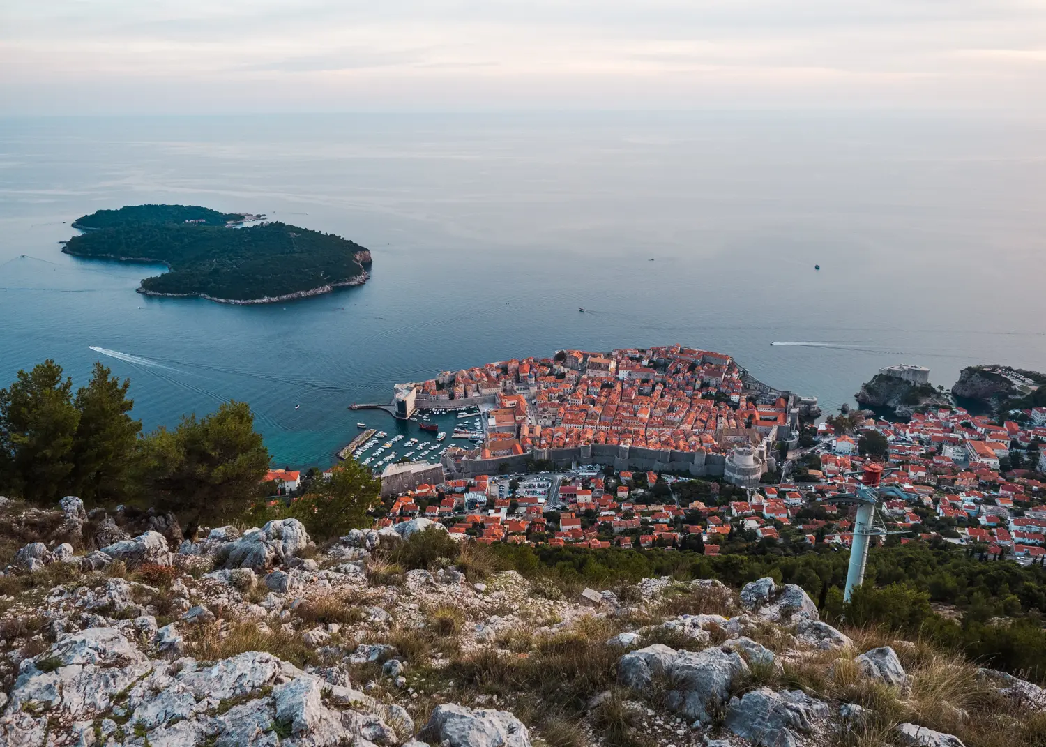 View from Mount Srd of Dubrovnik fortified Old Town with orange rooftops and ocean in the background - Hot to get to Mount Srd.