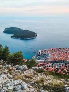 View from Mount Srd of Dubrovnik fortified Old Town with orange rooftops and ocean in the background - Hot to get to Mount Srd, cable car or hike?