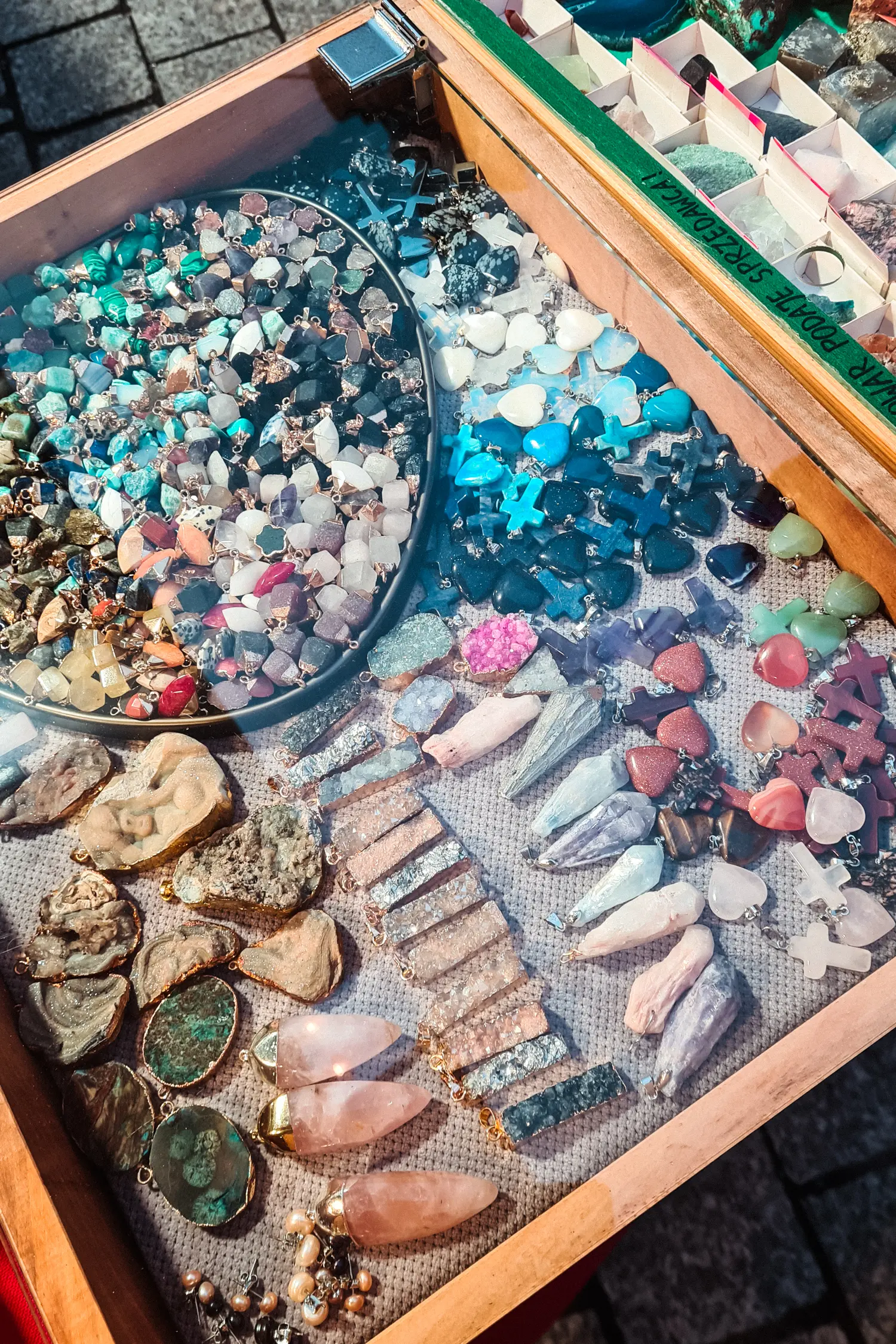 Glass case with colorful stones, crystals and pendants, one of the best things to buy at Wroclaw Christmas Market.