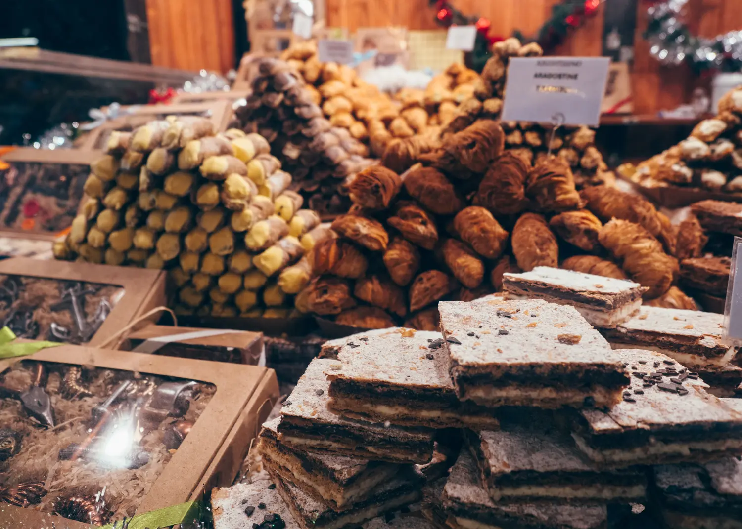 Counter with mountains of cannolis and other Italian pastries, one of the best snacks at Wroclaw Christmas Market.