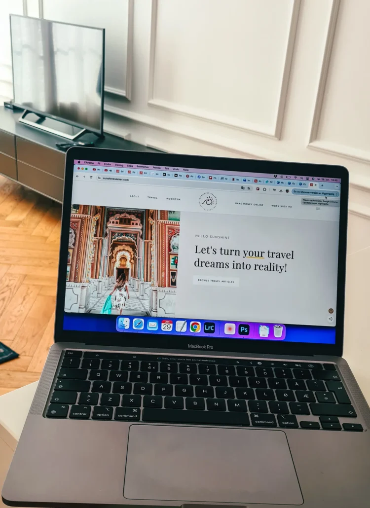 View of a laptop with travel blog Sunshine Seeker open on the screen, review Six-Figure Blog Builder.
