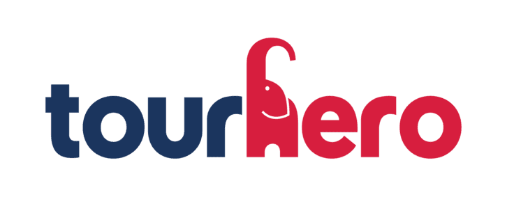 Dark blue and red TourHero (hosting group trips) logo with an elephant as the H.