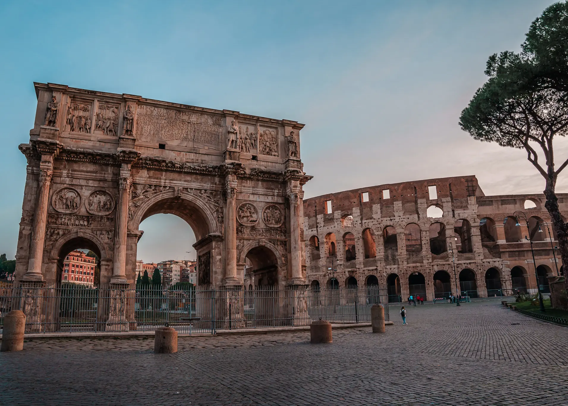 Looking towards the Colosseum and the Arch of Constantine, early in the morning in the Monti neighborhood, where to stay in Rome.