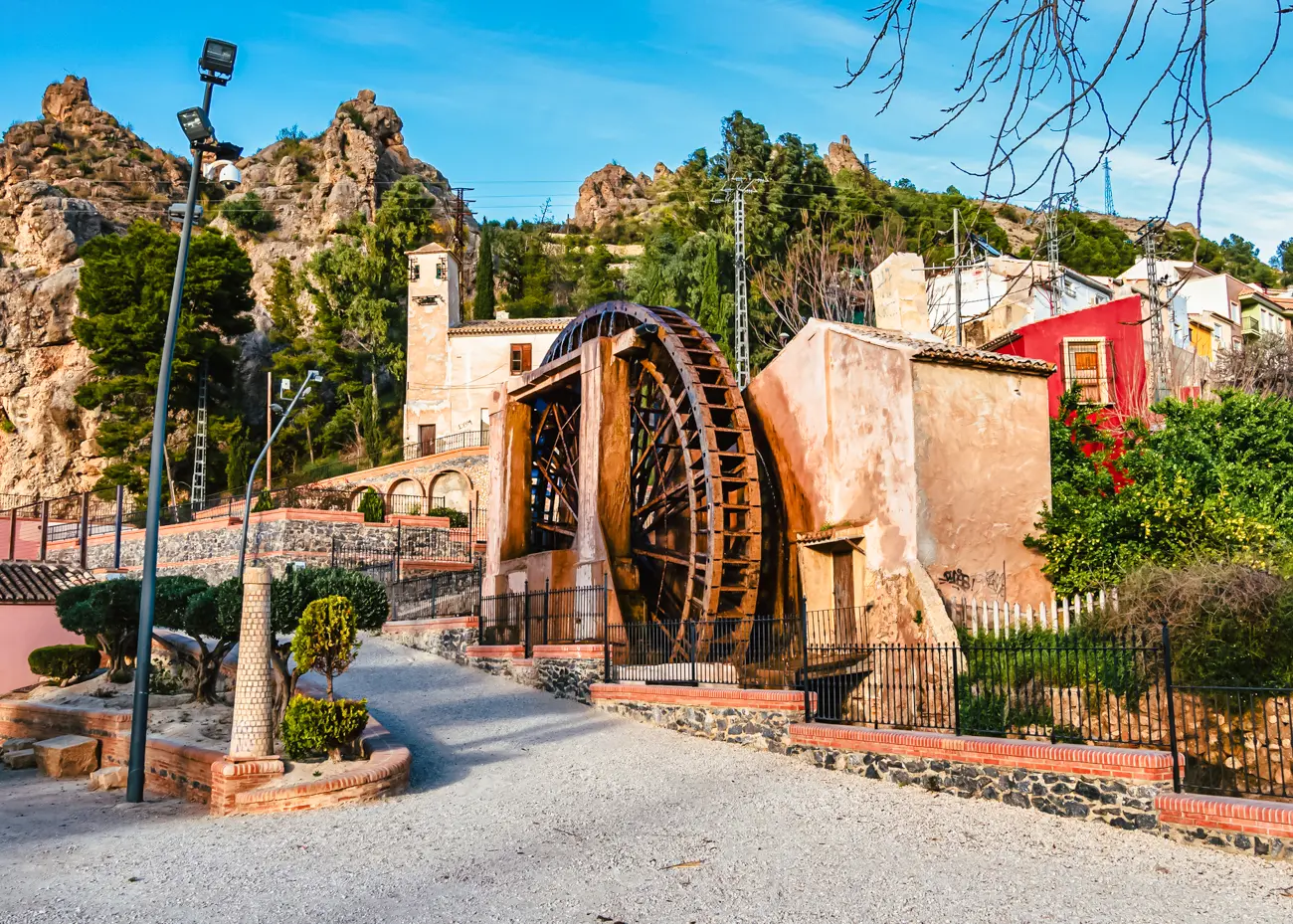 Large wooden waterwheel on the outskirts of the small town of Abarán on a sunny day in Ricote Valley.