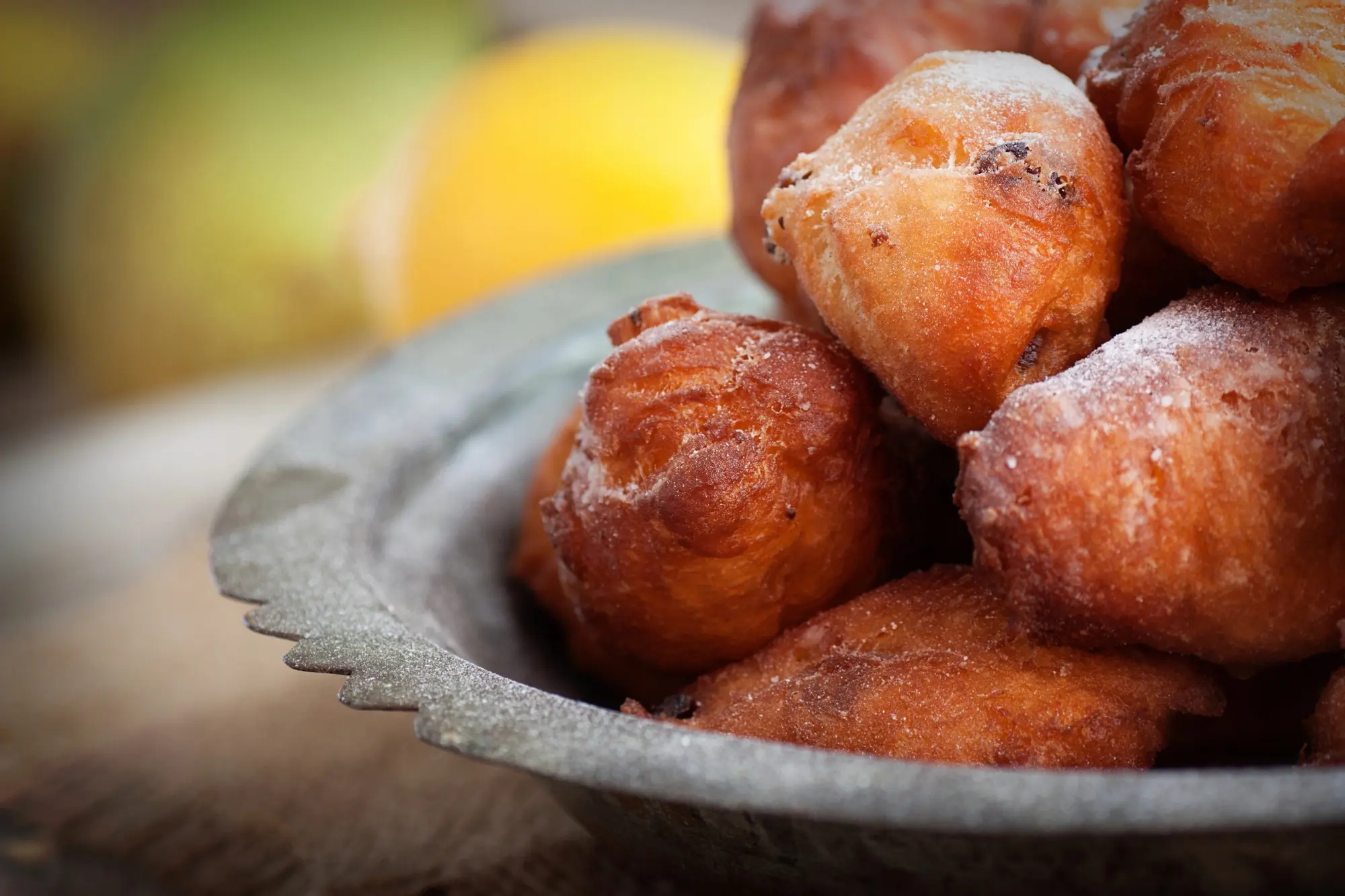 Close up of a metal bowl with fried donut balls called Oliebollen in Curaçao, things to know for first-timers.