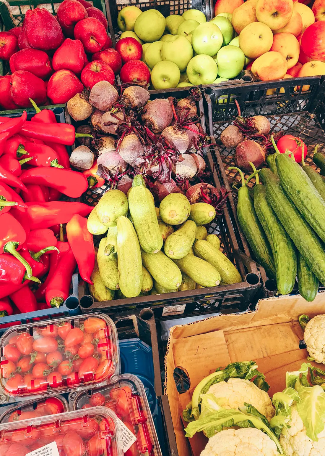 Close up of black crates of fruit and vegetables and Saranda Town Market - peppers, apples, tomatoes ++