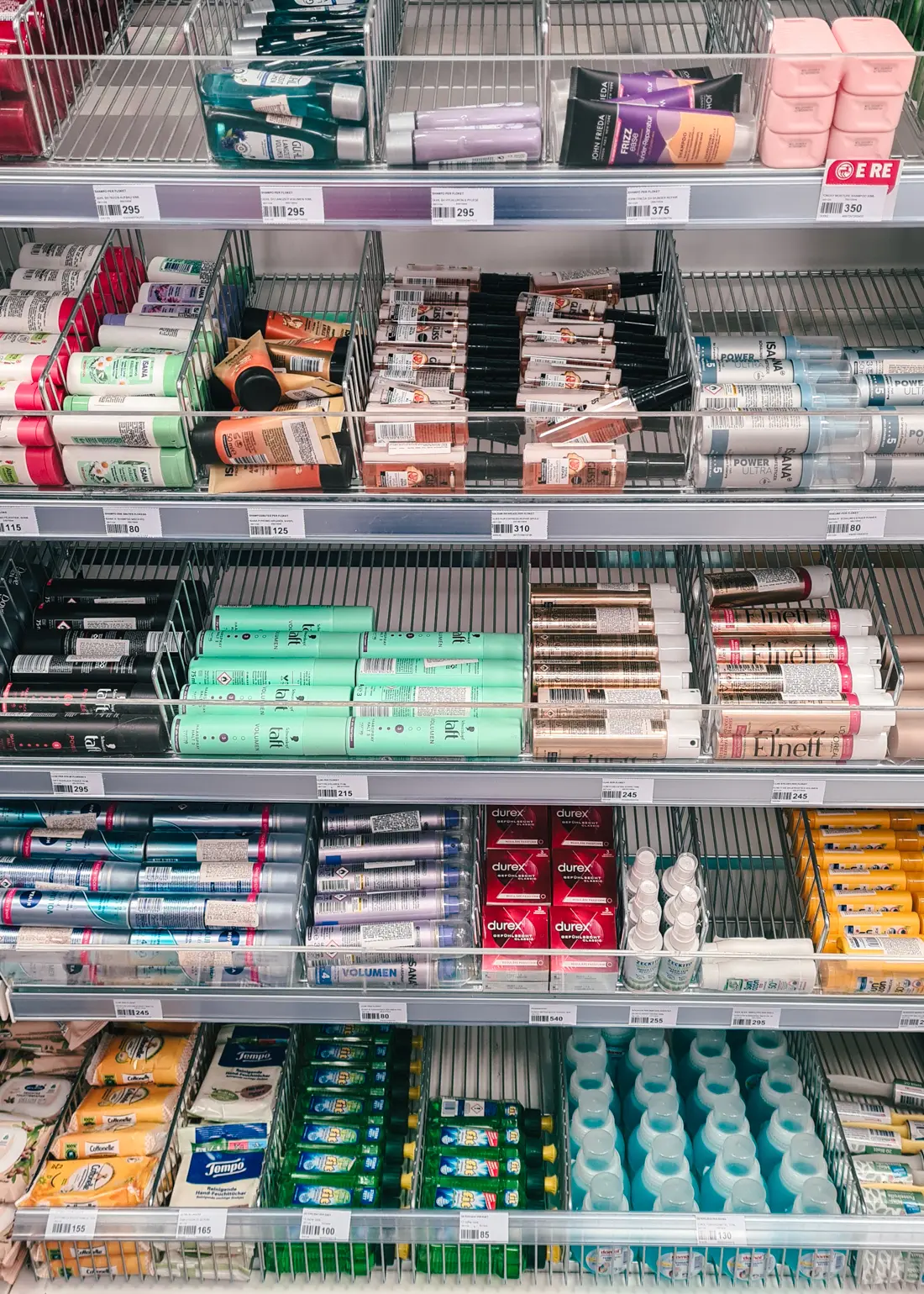 Close up of shelves with travel size beauty and cleaning products at Rossmann in Saranda, where you can also pay by card.