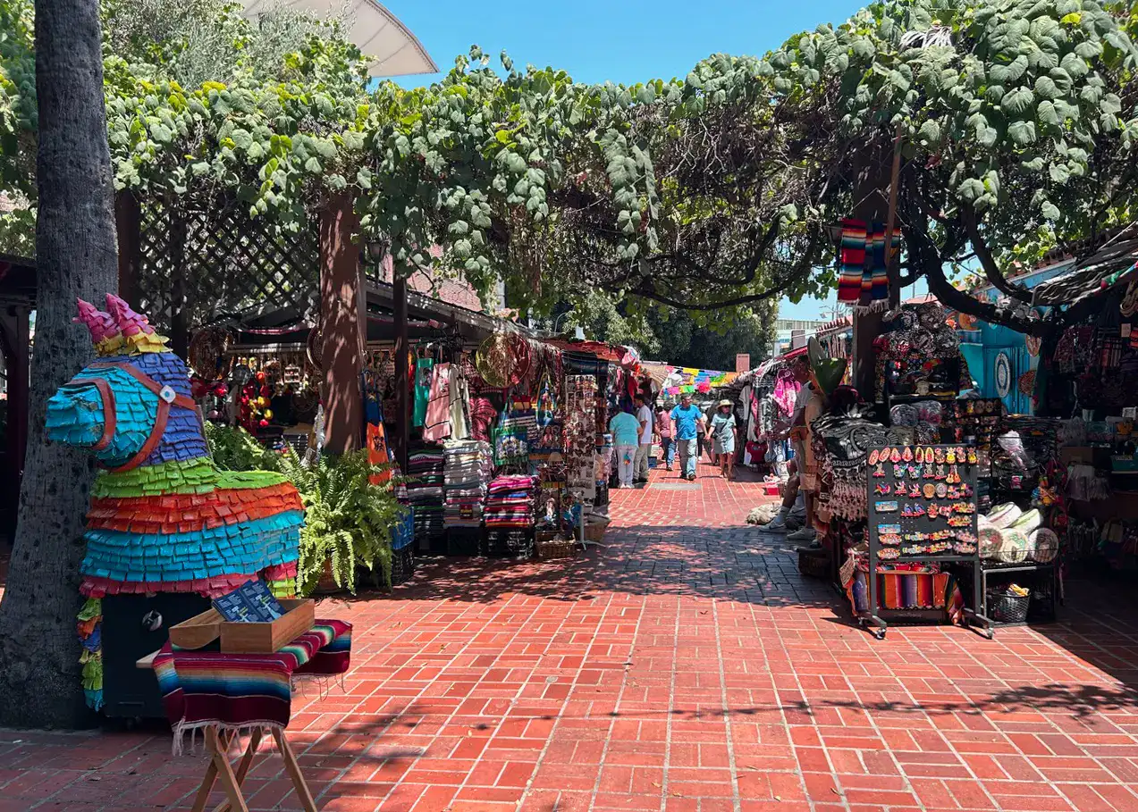 Olvera Street, a Mexican market and the oldest street in Los Angeles, tiled with Terracotta and lined with stalls on both sides. Greenery hanging above. A must during any LA itinerary.