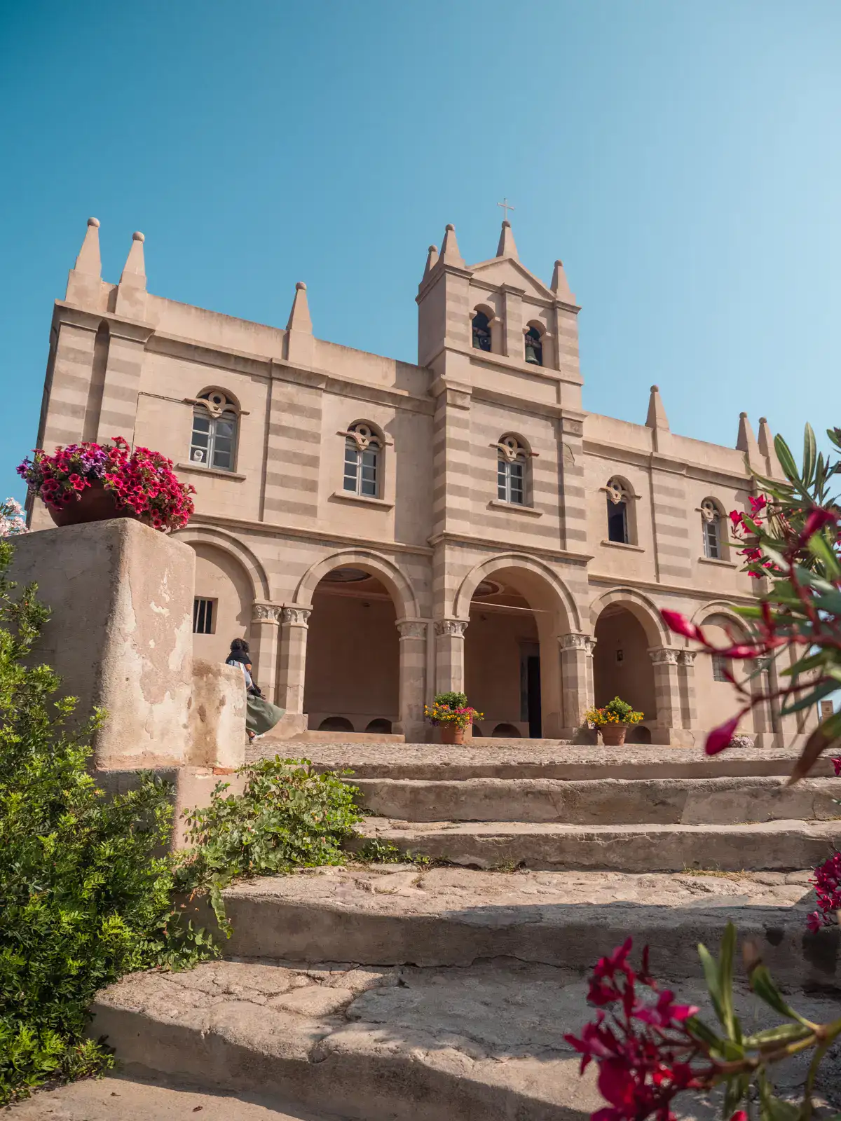 Santuario Santa Maria dell'Isola, a sand stone colored castle looking church on a hill in Tropea, Italy.