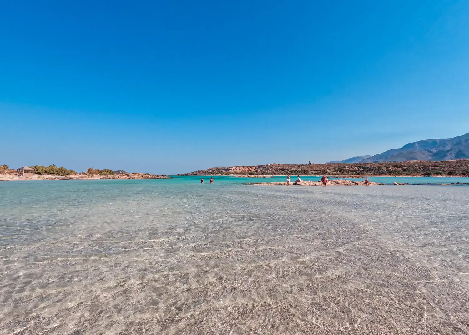 View of the shallow Elafonisi lagoon in Chania, with crystal clear, turquoise ocean, on a sunny day with blue skies in October.