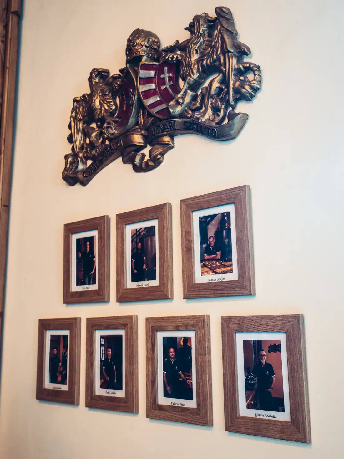 Close up of 7 frames with photos of workers in the Zwack Unicum Factory in Budapest.