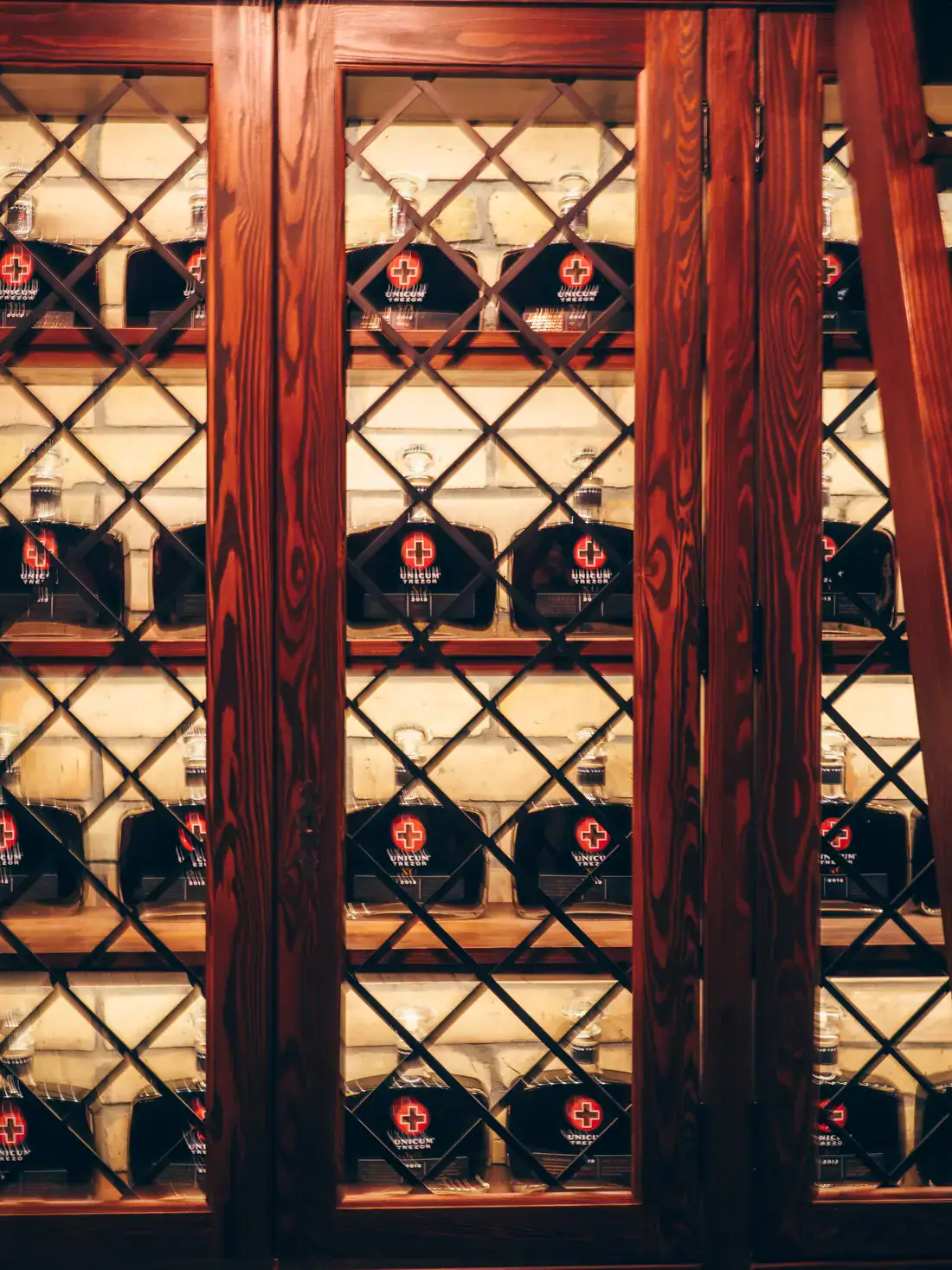 Special edition Unicum bottles, behind glass in a wooden cupboard in the cellar of the Zwack Unicum Factory in Budapest.