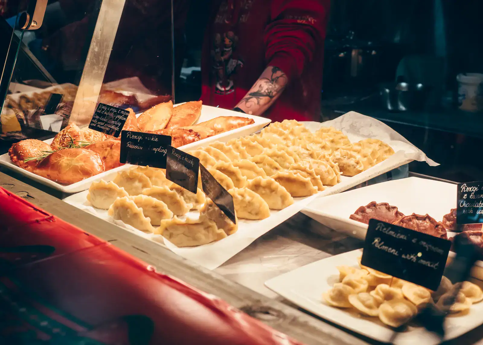 White treys of different shaped pierogi with small, black signs at Gdansk Christmas Market.