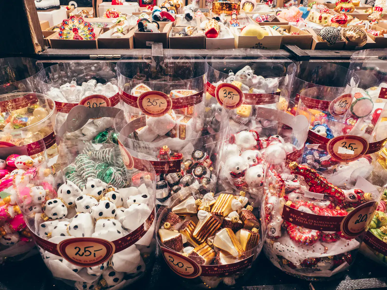 Clear containers with different Christmas tree baubles, dogs, snowmen, cars, cakes and many more, ranging in price from 20-40 PLN at Gdansk Christmas Market.