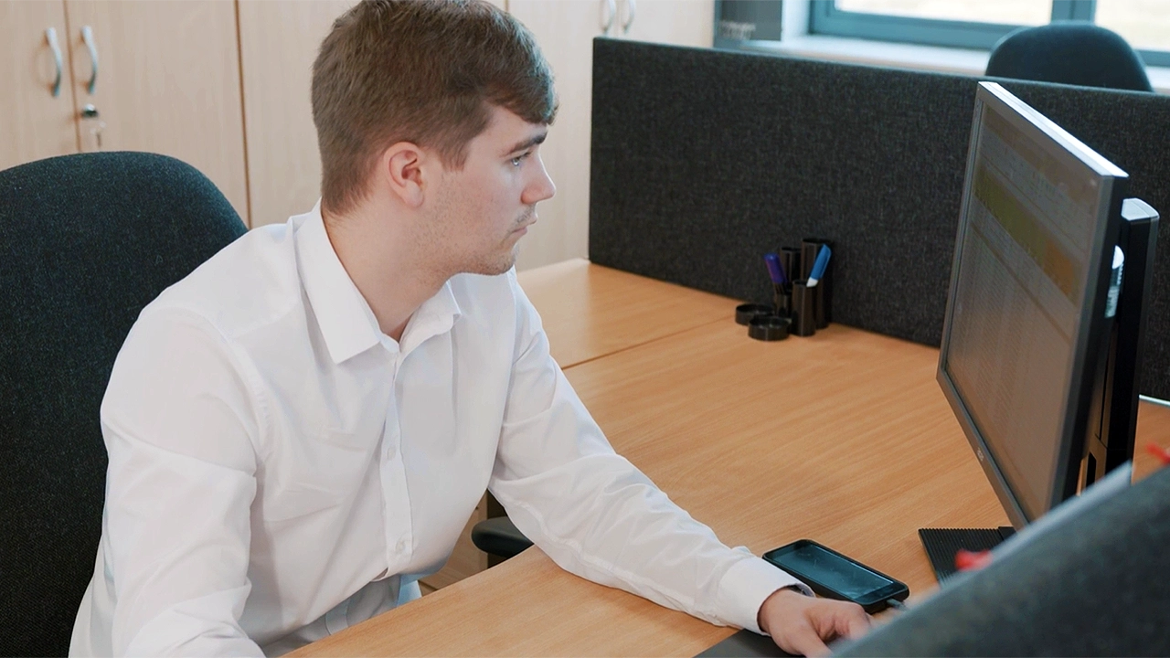 Employee working at a computer in the head office