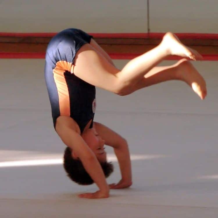 young gymnast forward rolling