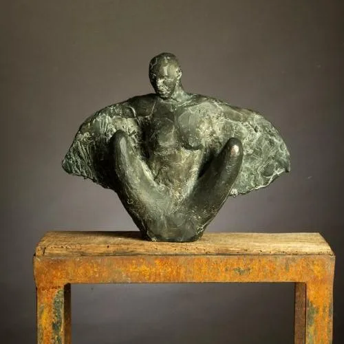 A statue of a man on a wooden table