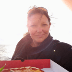 Enjoy the sunset in Malmö while eating a pizza from Vespa by the seaside.
