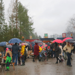 People with umbrellas in Skansen, Stockholm.