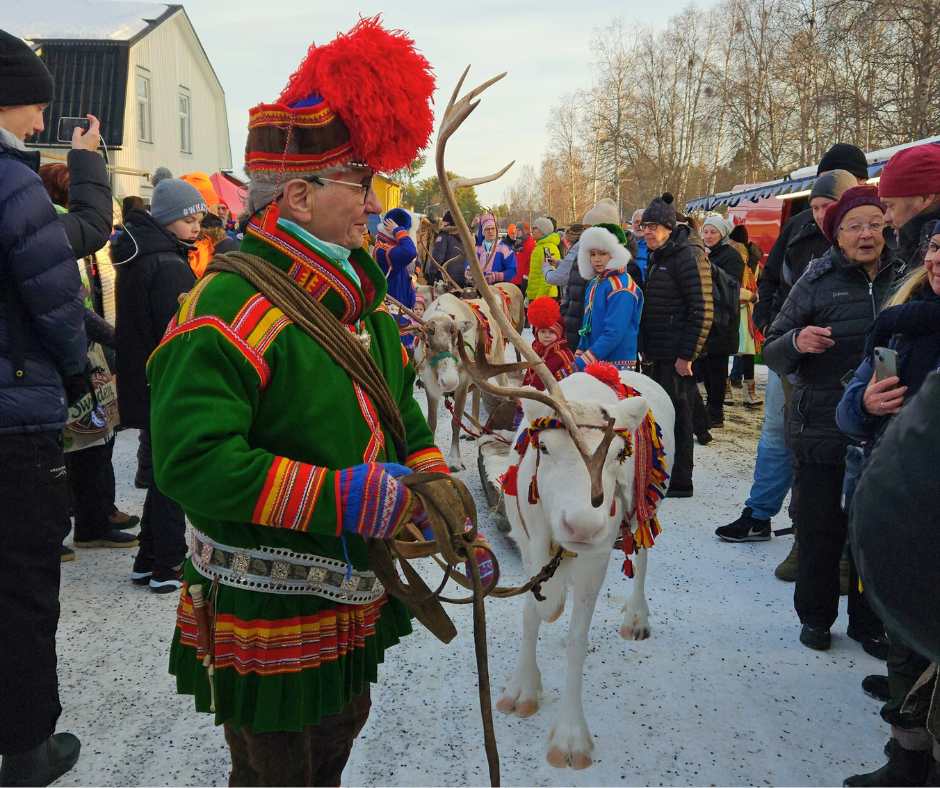 Sami herder with reindeer during the reindeer parade at Jokkmokk market.