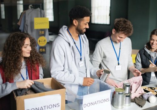 group-of-volunteers-working-in-community-charity-donation-center-1.jpg