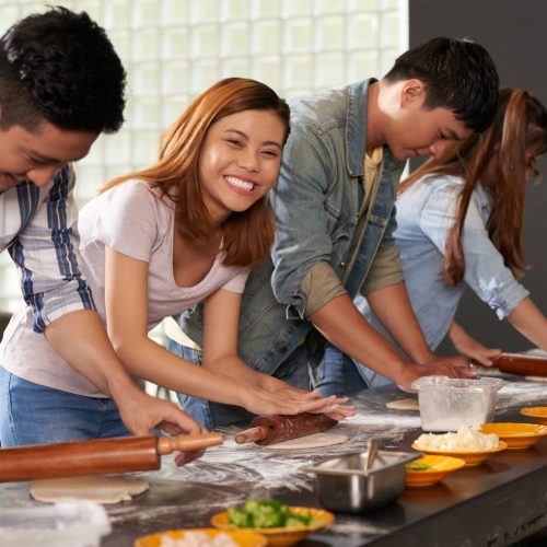 Four-people-cooking-together-at-a-cooking-school