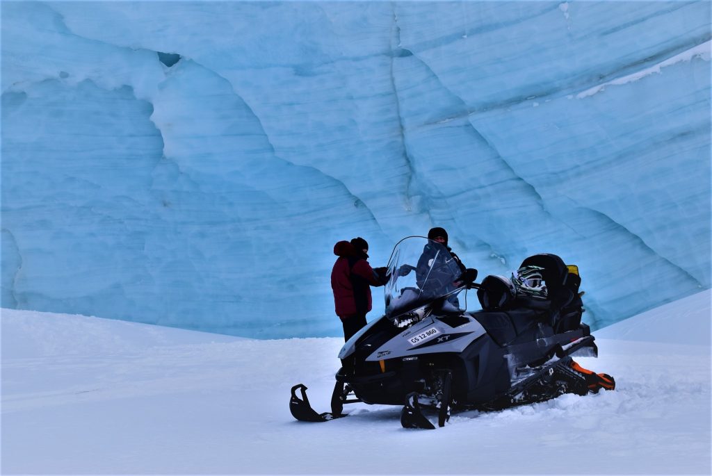 Snowmobile in front of glacier
