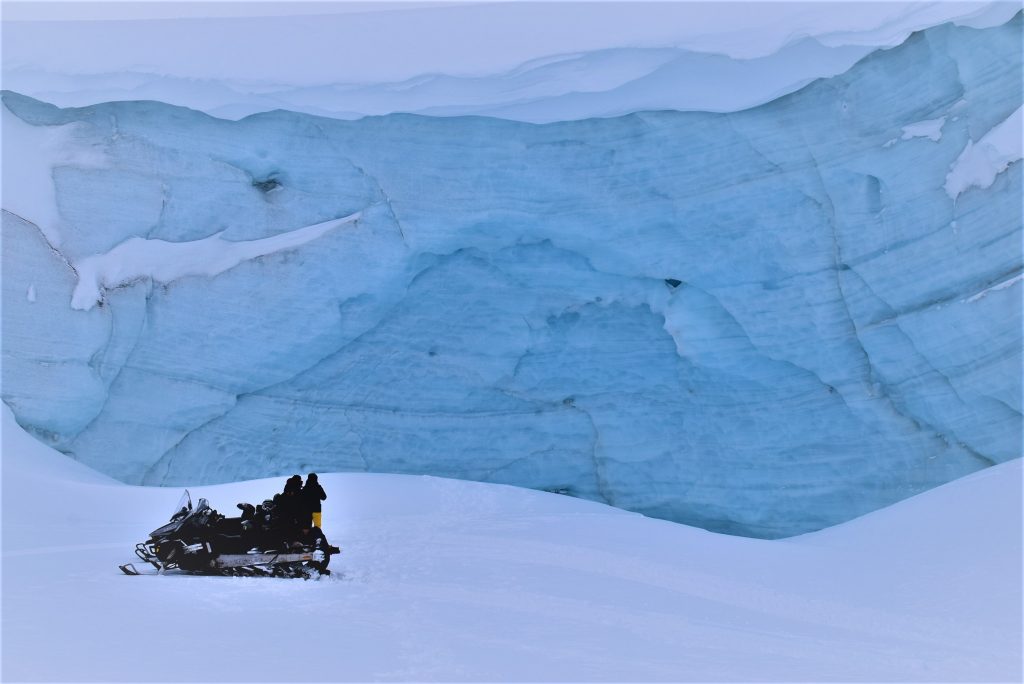 Snowmobile in front of glacier
