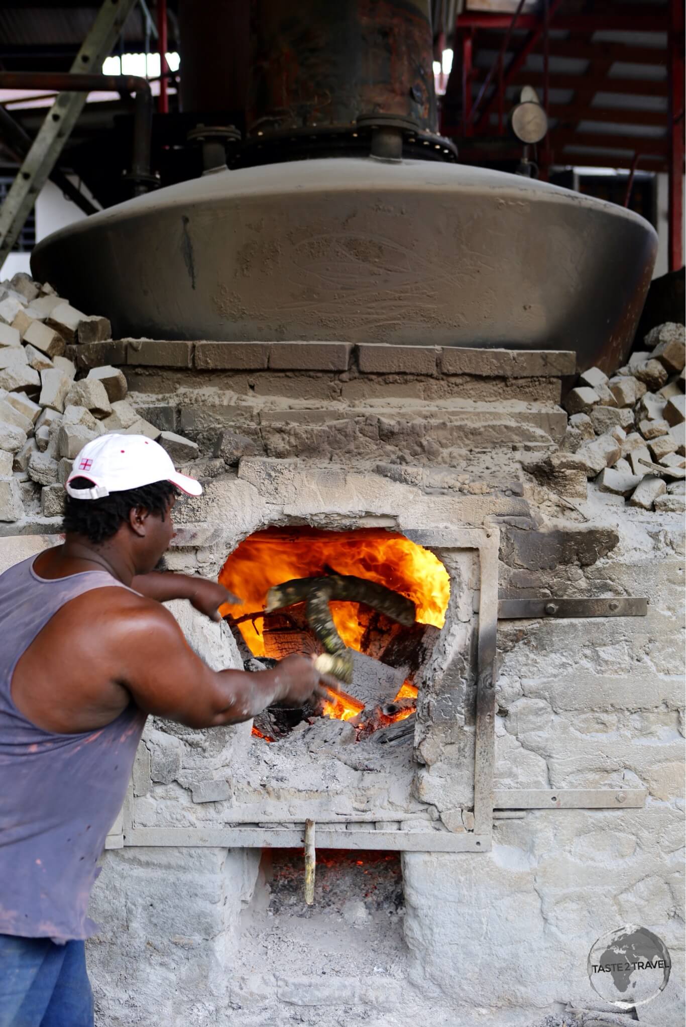 Firing the vats of alcohol at the River Antoine distillery.