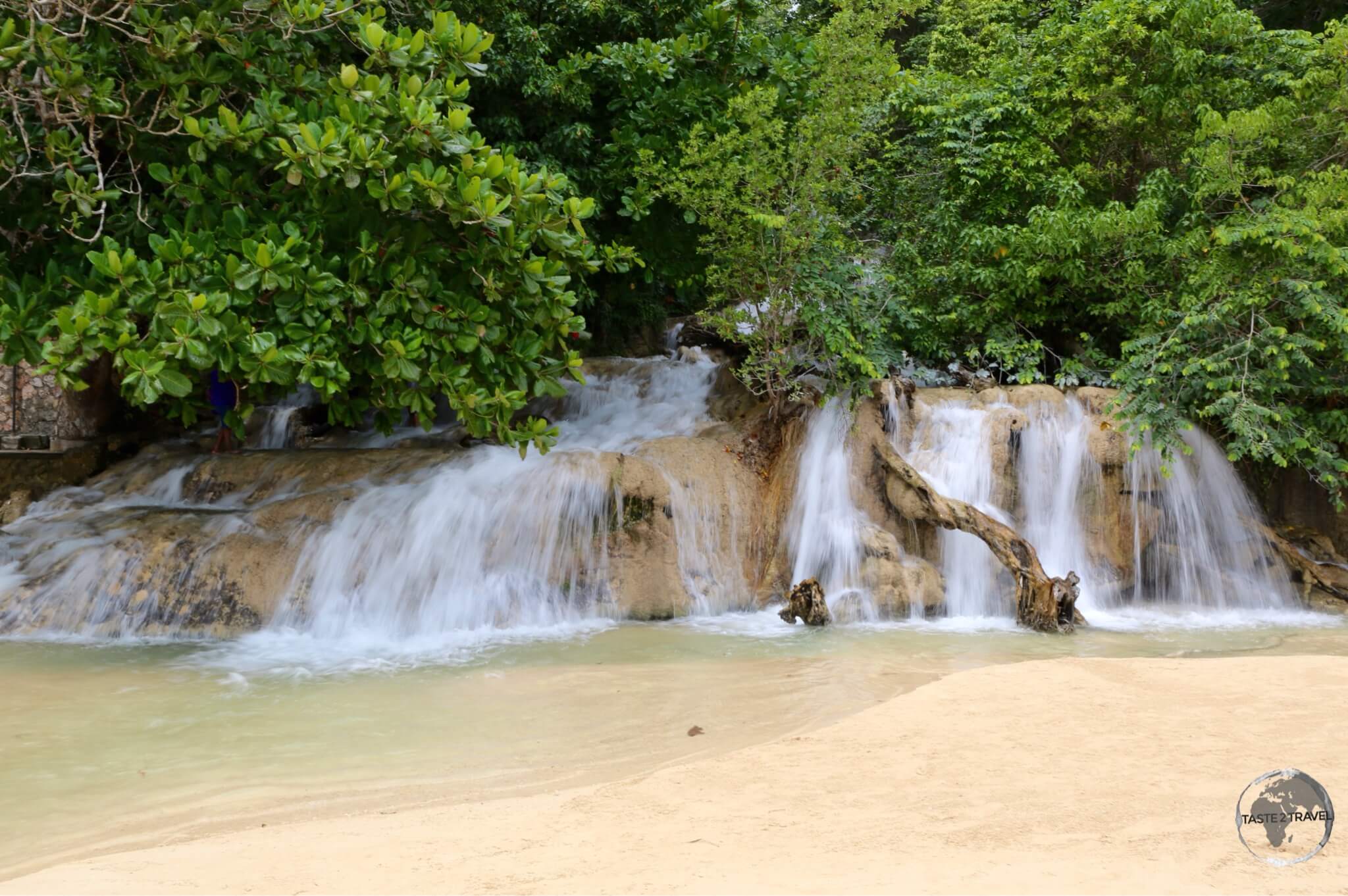 Dunn's River falls cascading onto the beach near Ocho Rios.