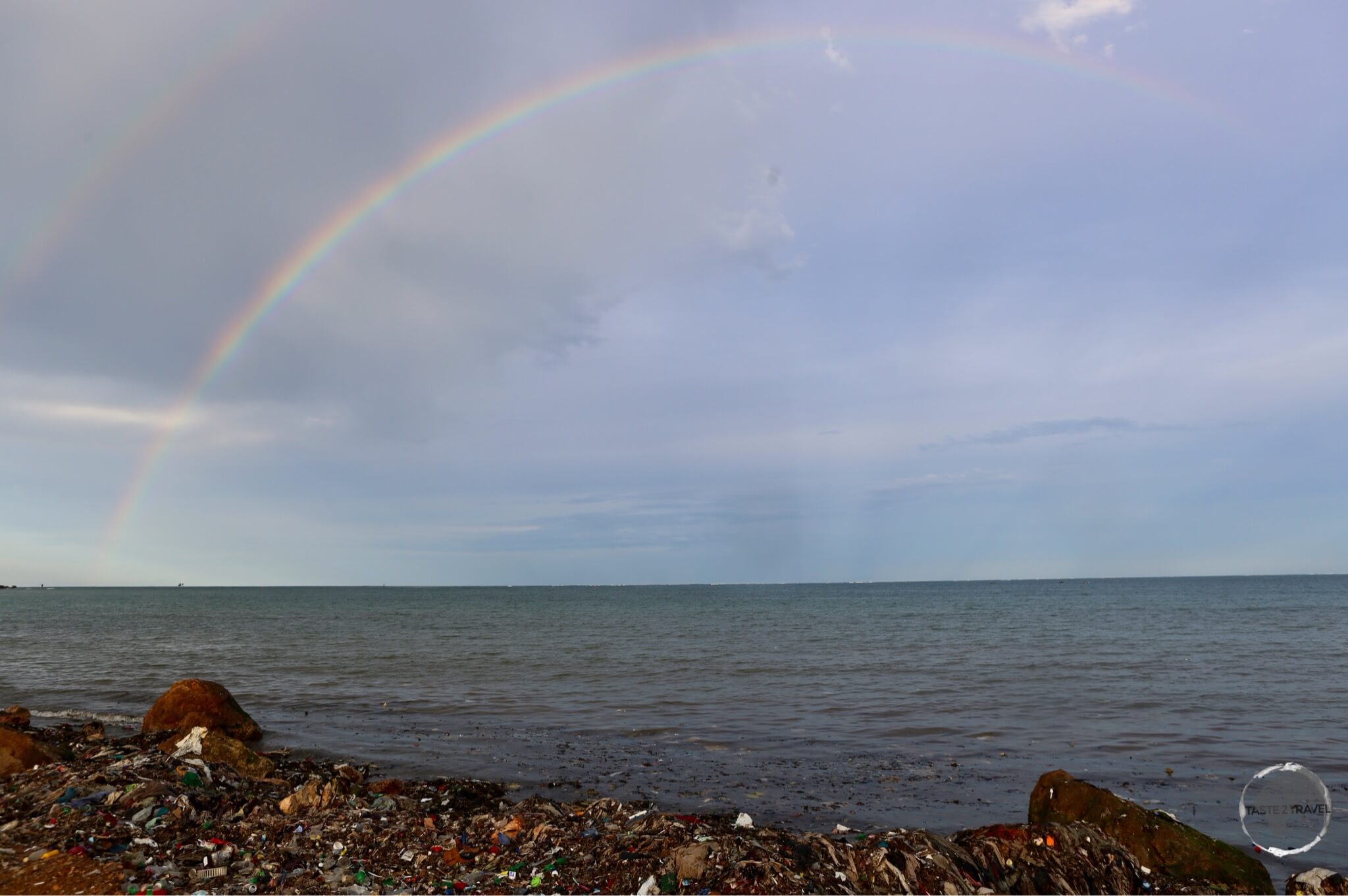 Rainbow over a heavily polluted beach in Cap-Haïtien.