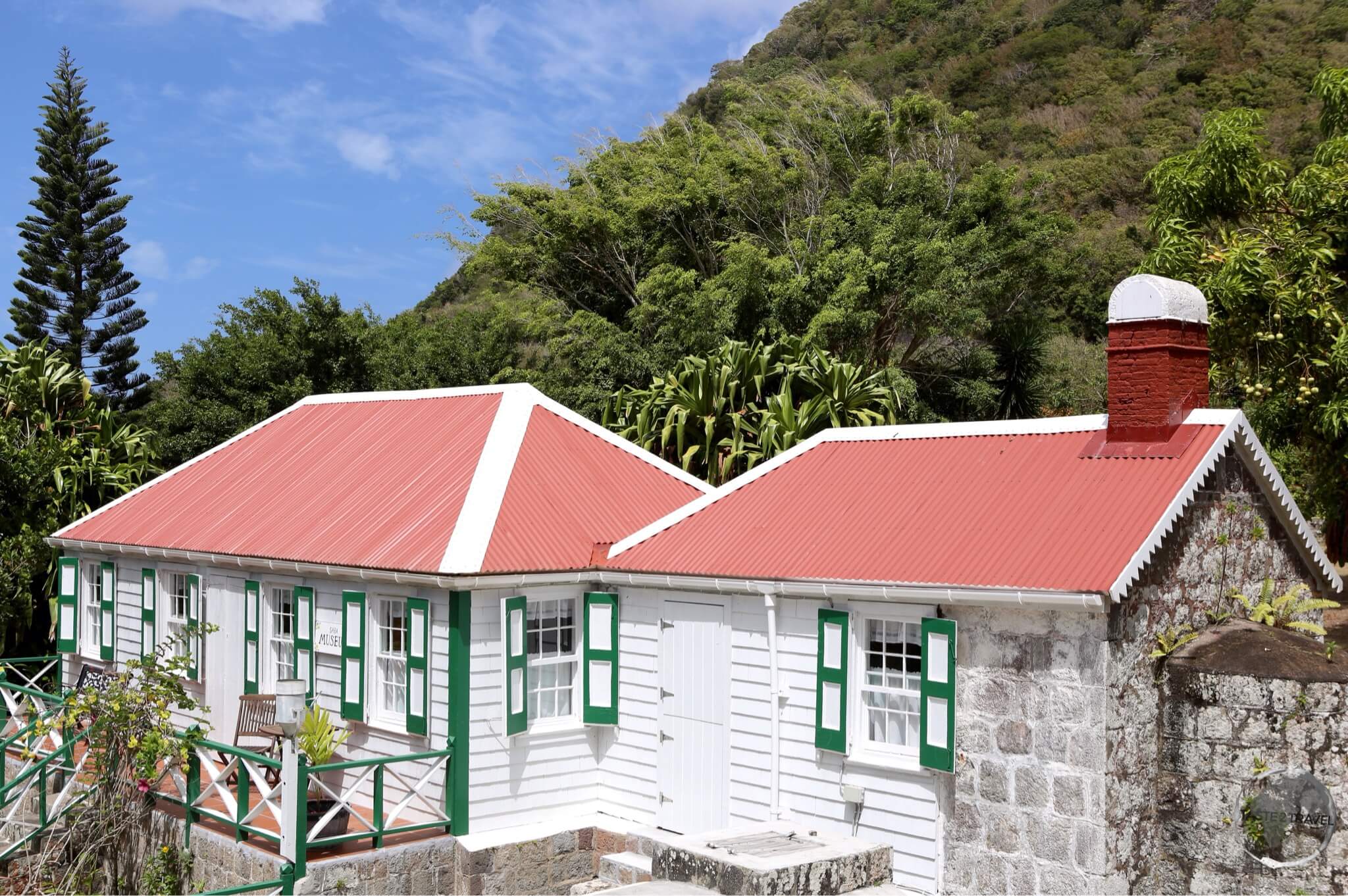 A strict building code on Saba ensures all buildings, such as these cottages in Windwardside, are a uniform white, with green trim and red roofs.