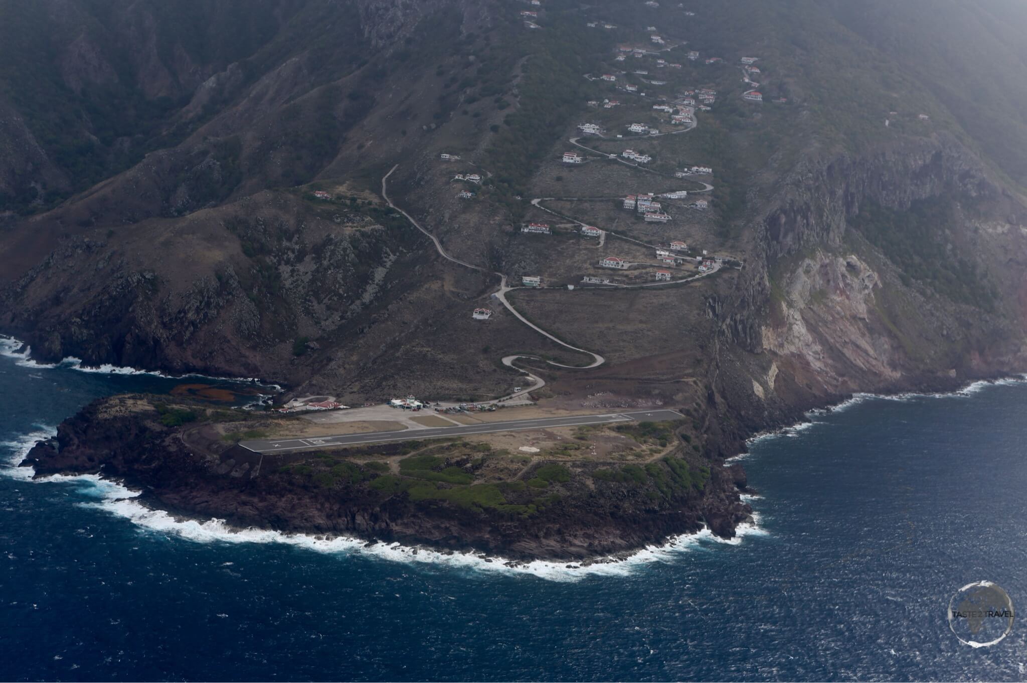 Saba Travel Guide: This view of Saba airport, shortly after take-off, shows the perilous position of the short runway.