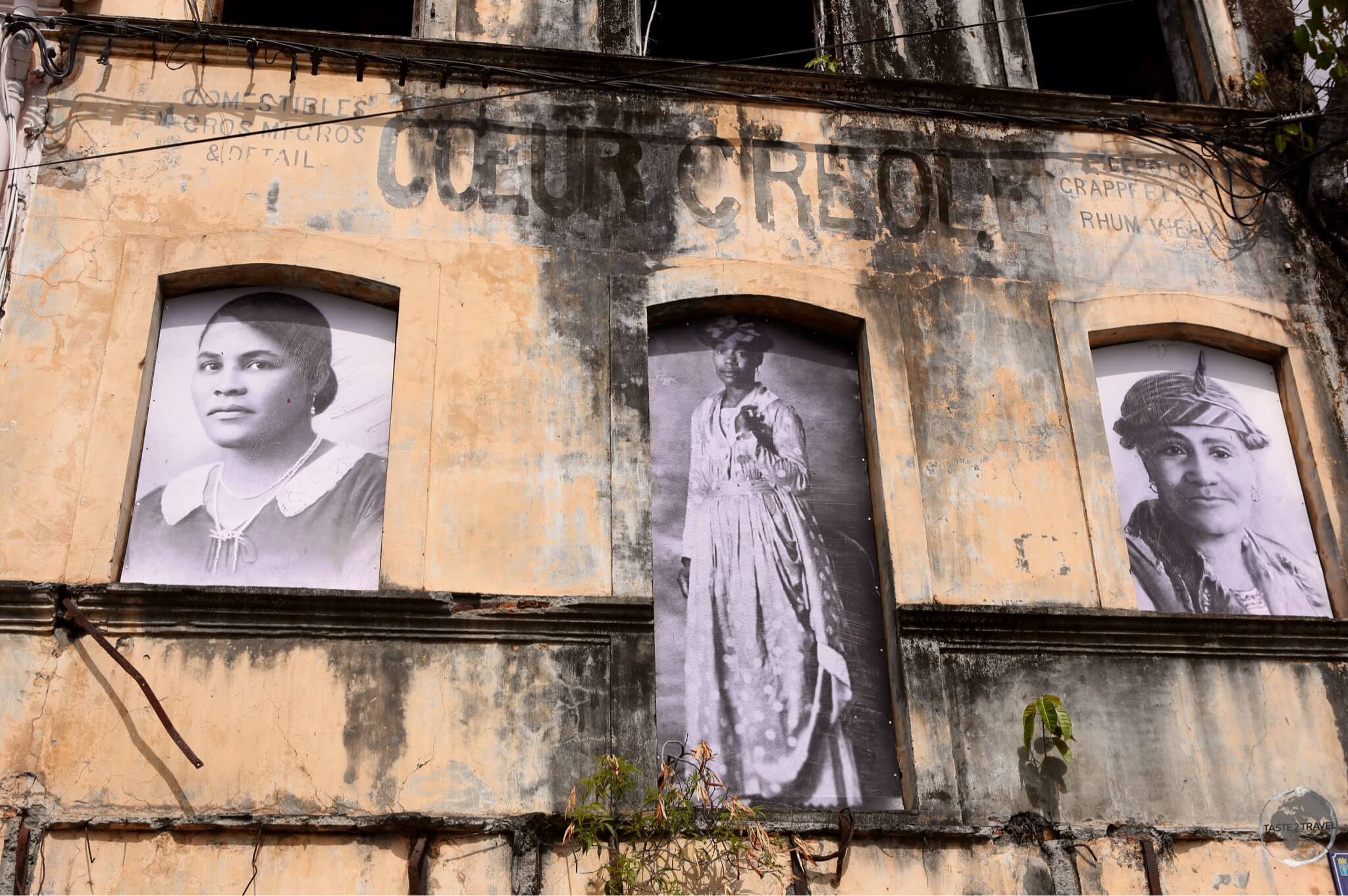 A ruined building in St. Pierre displays photos of some of the victims of the volcanic eruption which destroyed the former capital.