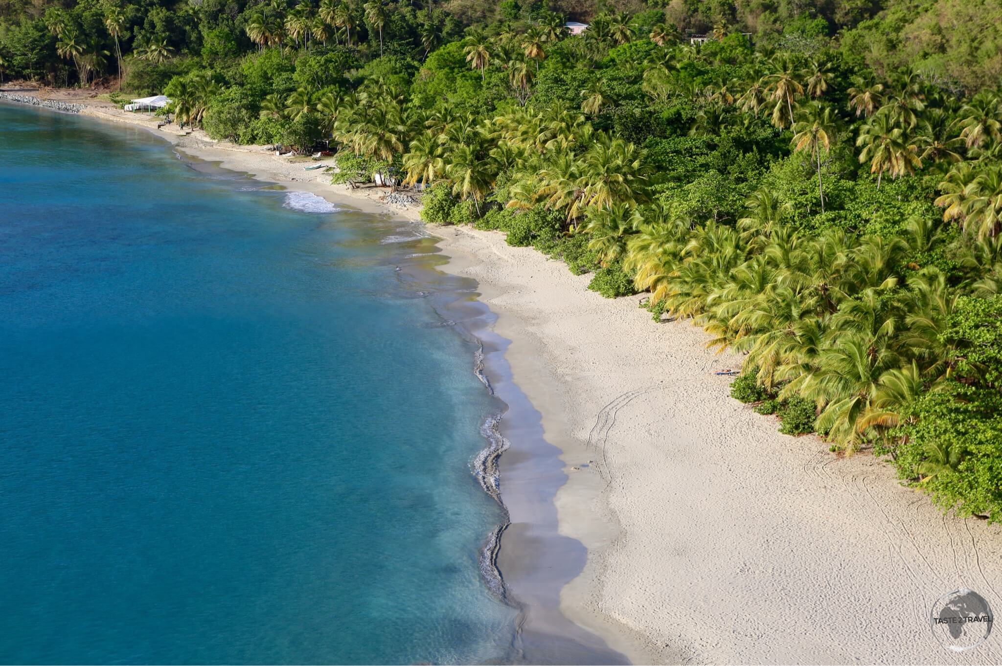 A sweeping view of Brewers Bay, BVI, where lush rain forest meets the sea.