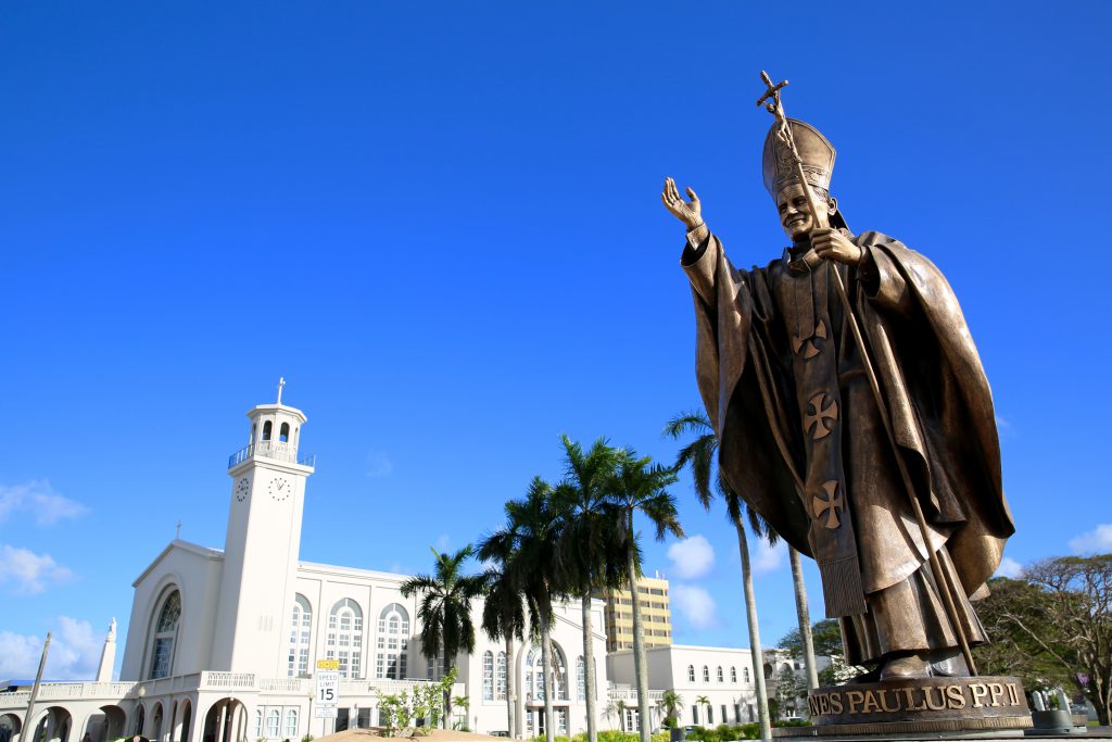 Statue of Pope John Paul II and Dulce Nombre de Maria Cathedral Basilica in Hagåtña.