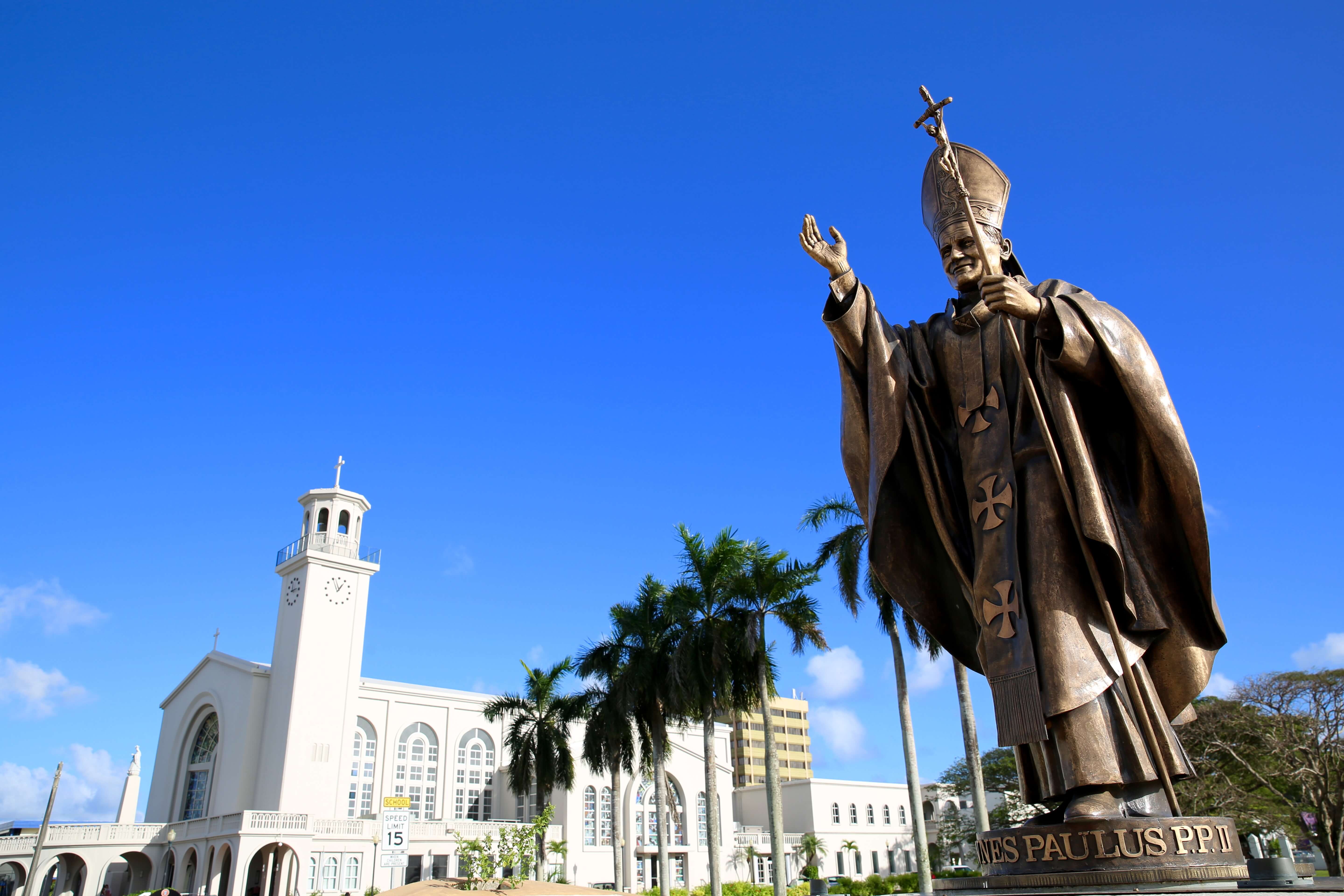 Statue of Pope John Paul II and Dulce Nombre de Maria Cathedral Basilica in Hagåtña