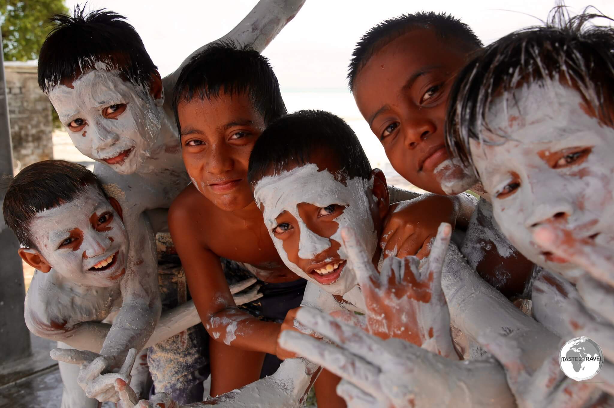 Young Kiribati boys playing in the tidal mudflats on South Tarawa. 