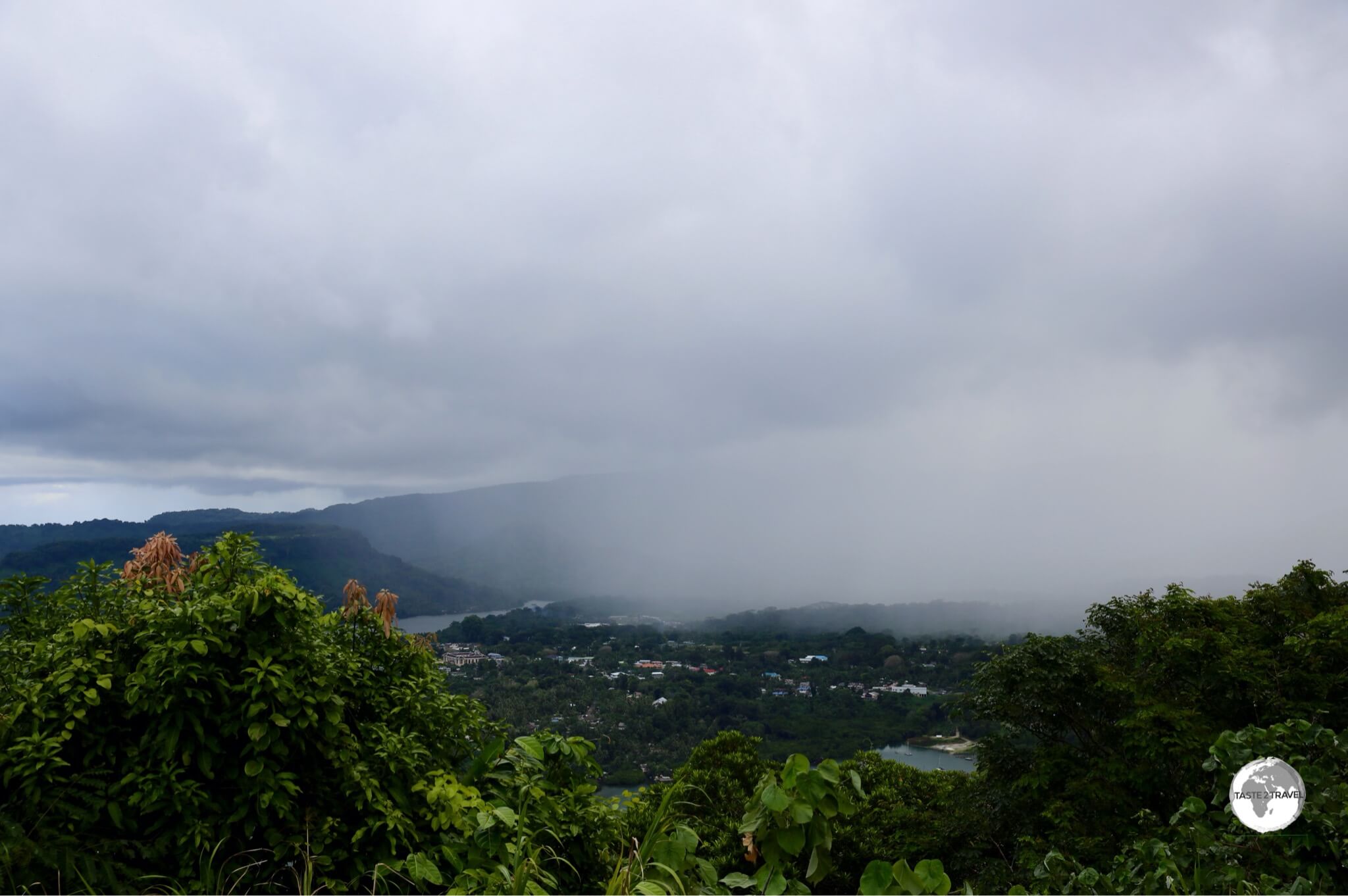 A storm moving over Kolonia, the capital of Pohnpei, as seen from Sokehs ridge.