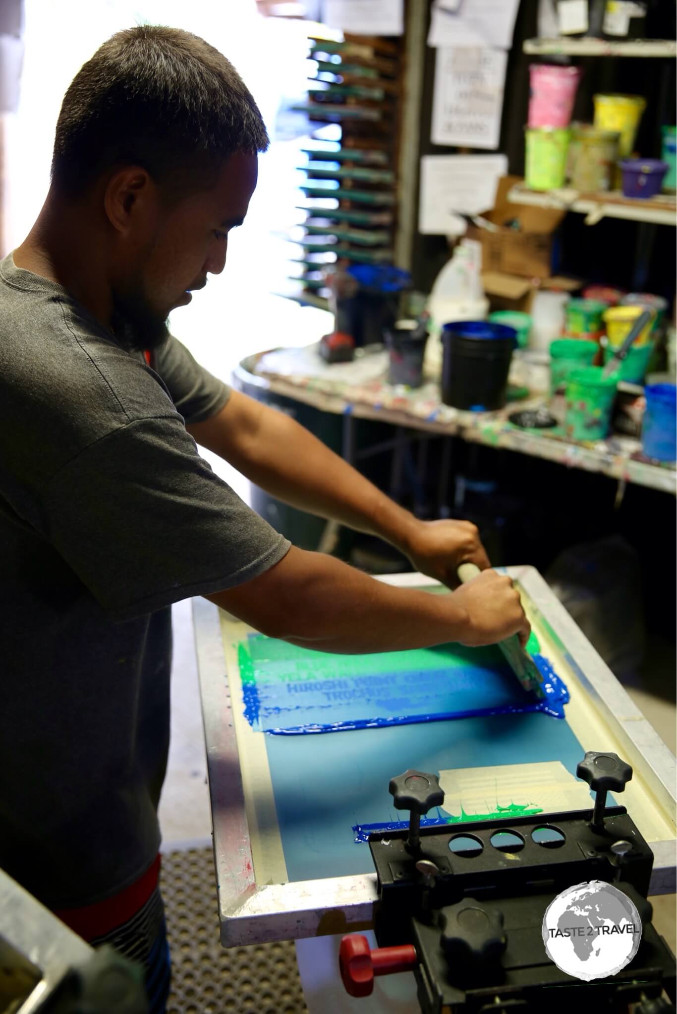 Screen printing the design onto the t-shirt.