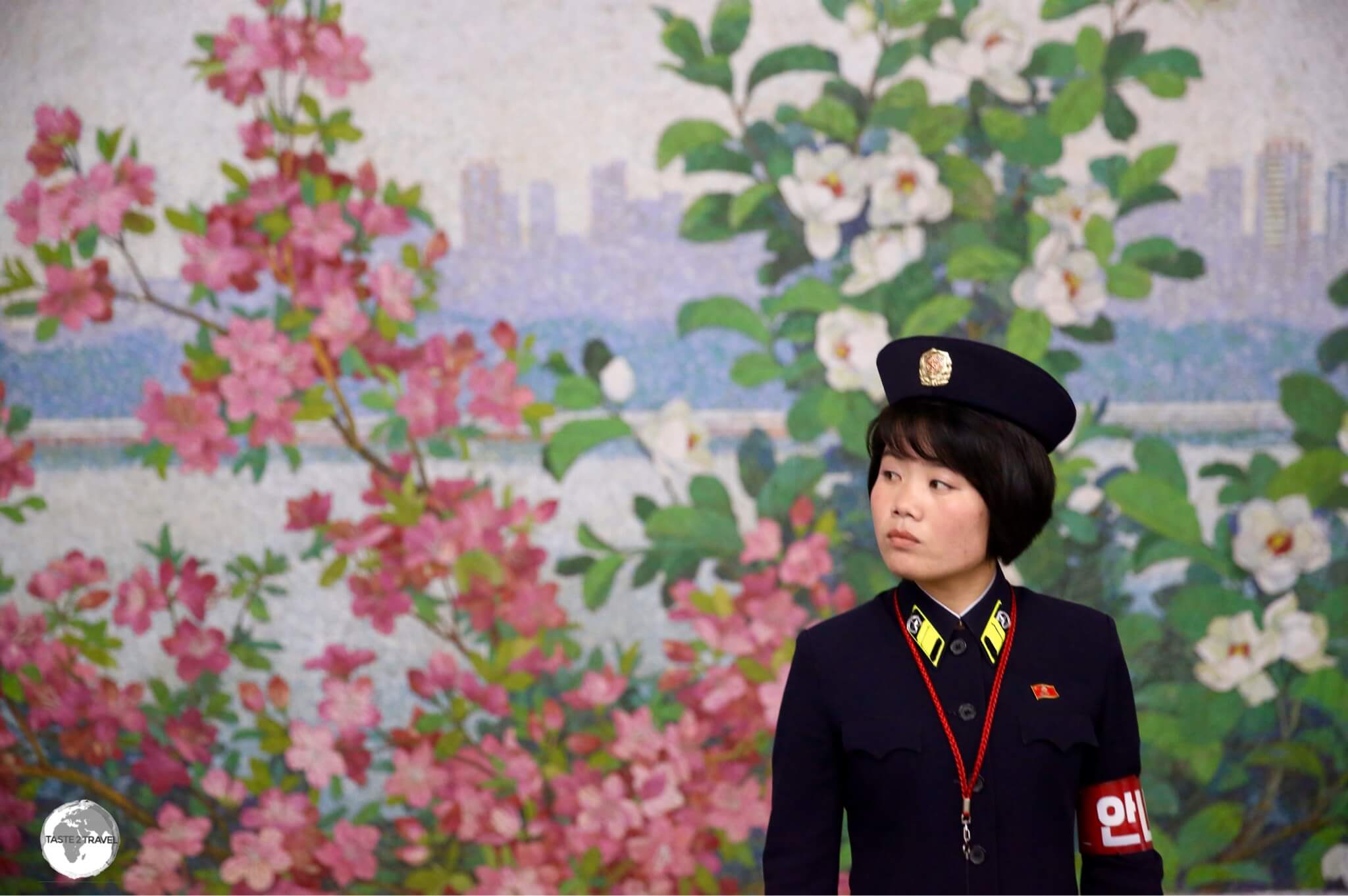 Metro guard on Yonggwang metro station. The walls of the platform are adorned with 80-metre-long mosaics depicting the Taedong river, which flows through Pyongyang.