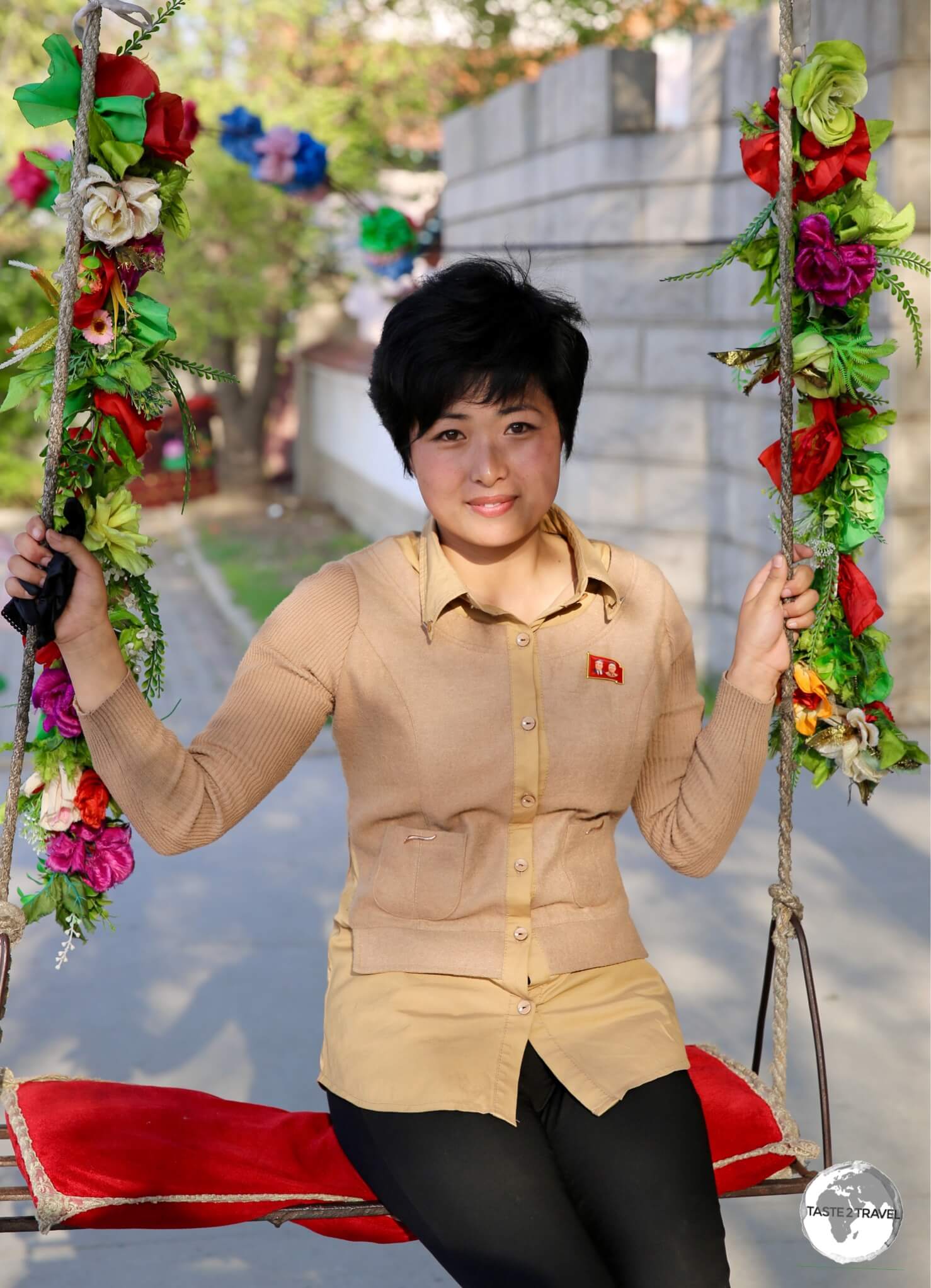 A <i>propaganda-poster-in-a-photo</i>, a Korean girl in the town of Sariwon.