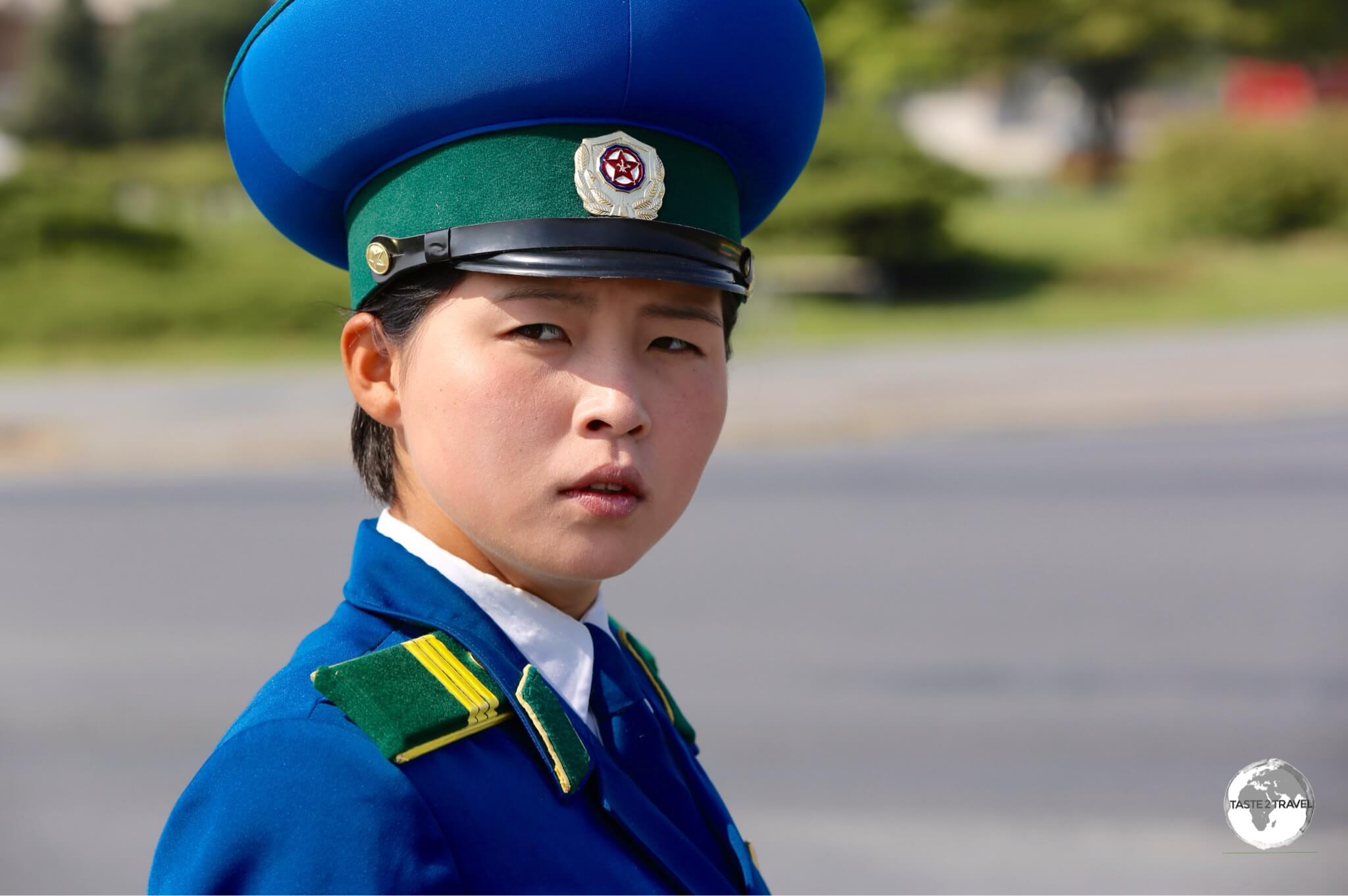 North Korea Travel Guide: Traffic policewoman in Pyongyang. Most drivers are male so the state employs young, attractive female officers as they believe the male drivers pay them more respect.