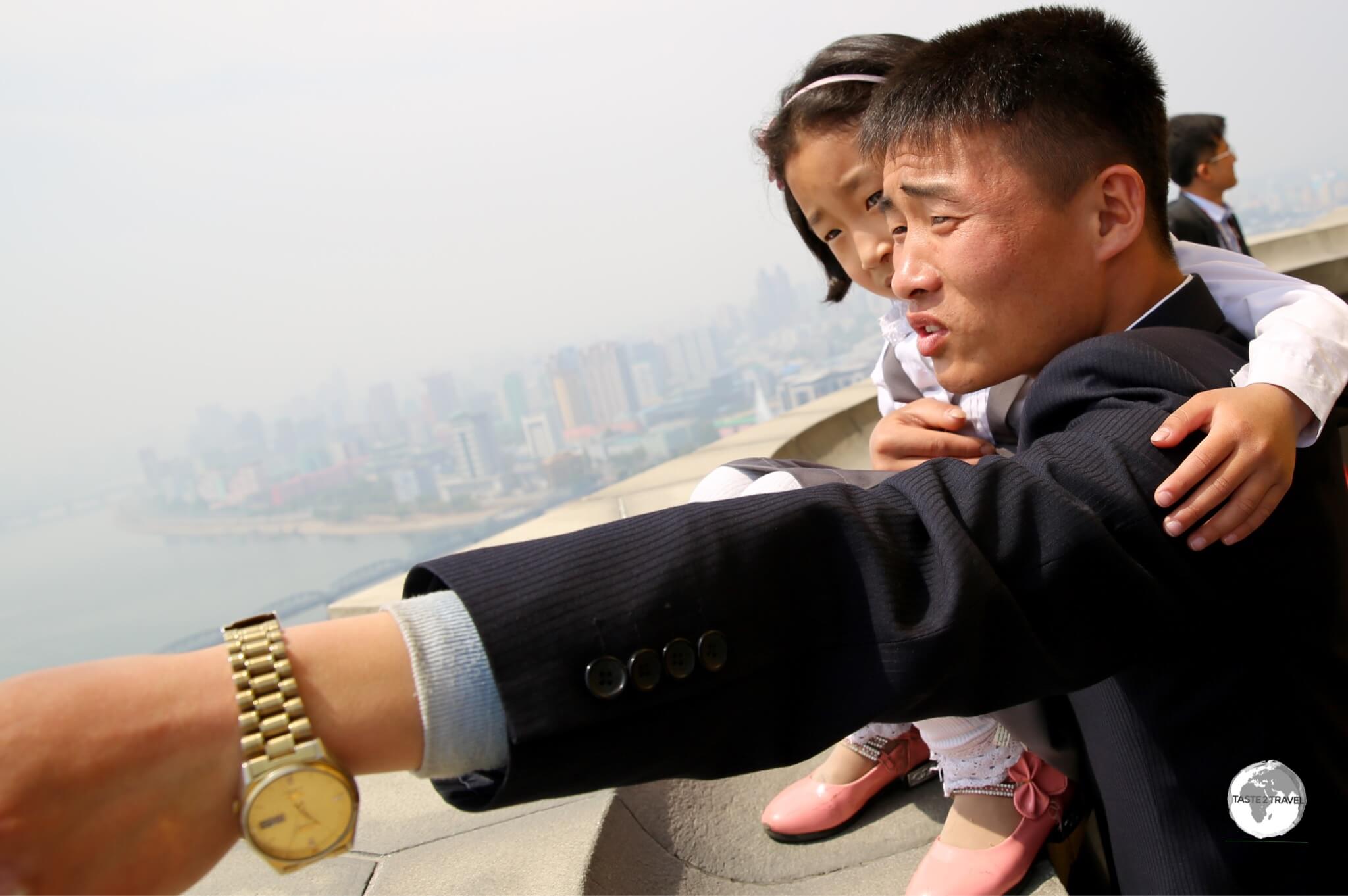 A North Korean family enjoying the panoramic views of Pyongyang from the top of the Juche Tower.